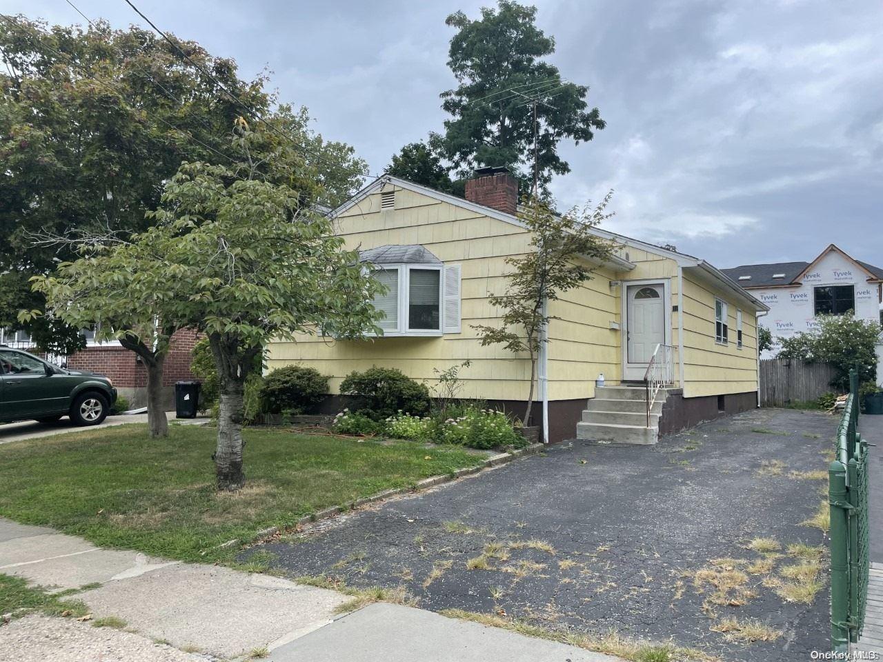 a view of a house with a yard and tree s