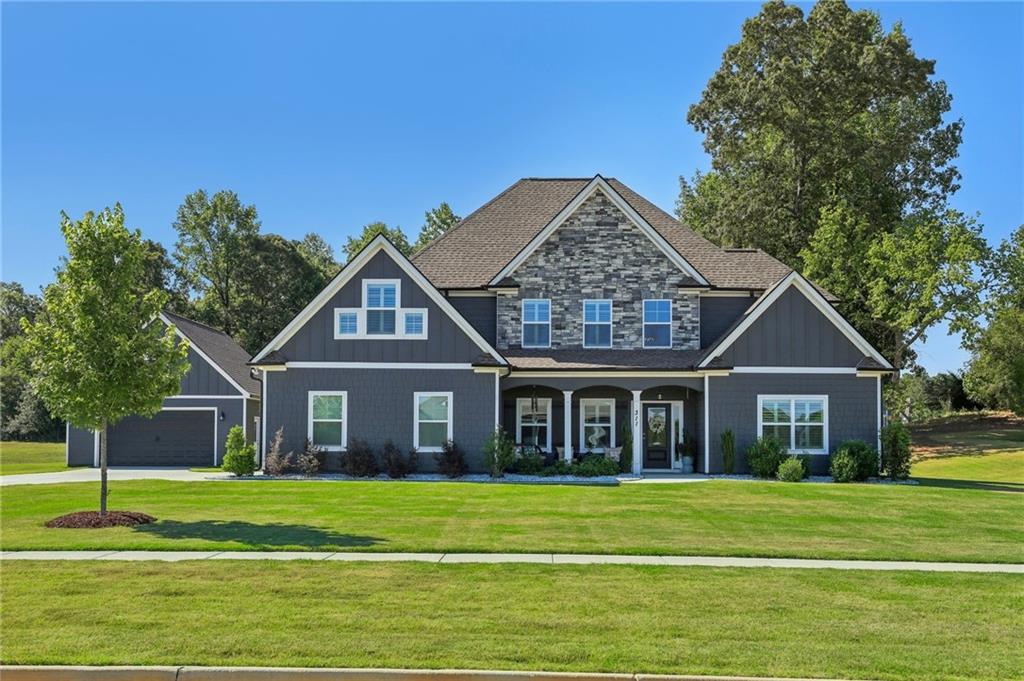 a front view of a house with a garden