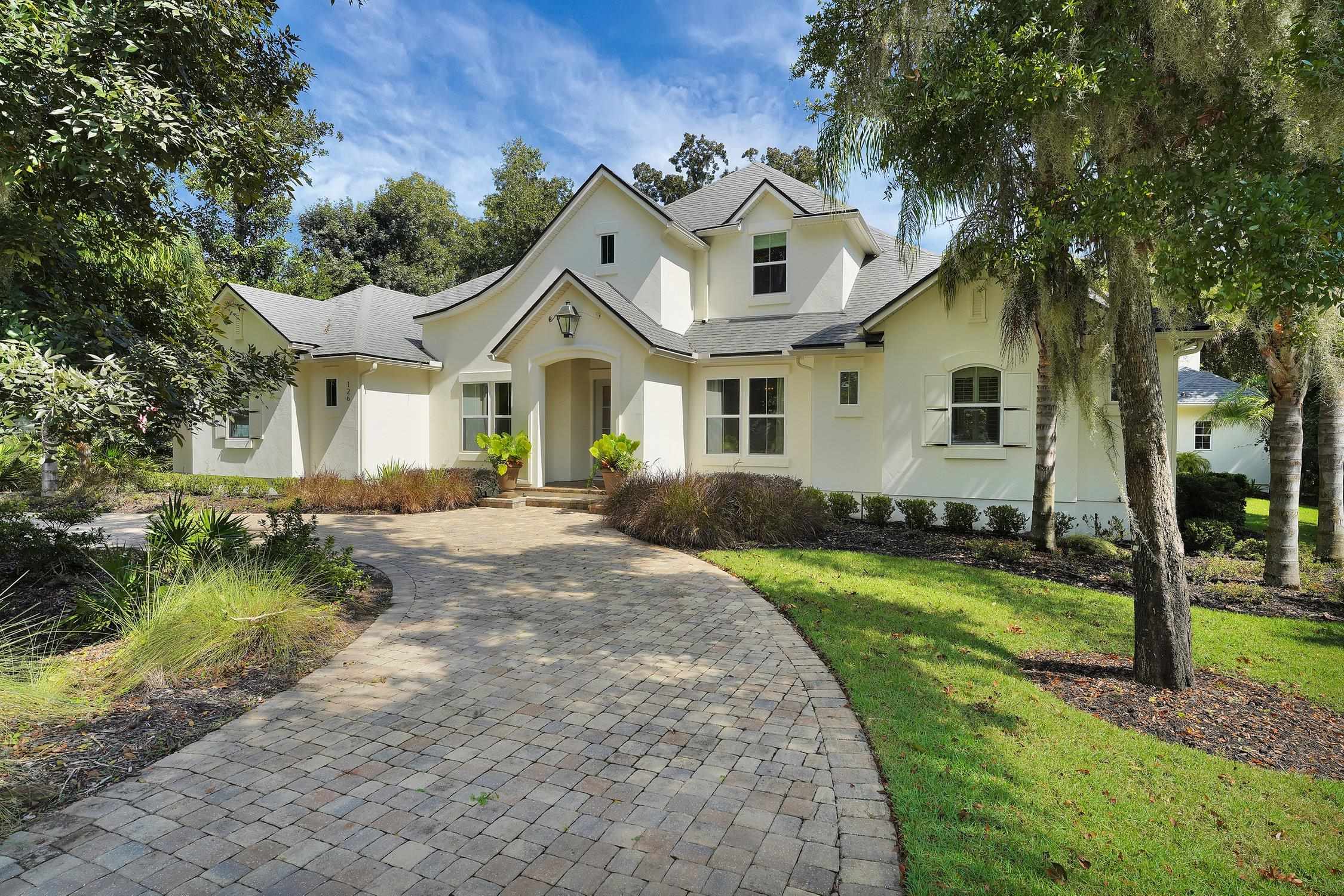 a front view of a house with a yard and porch