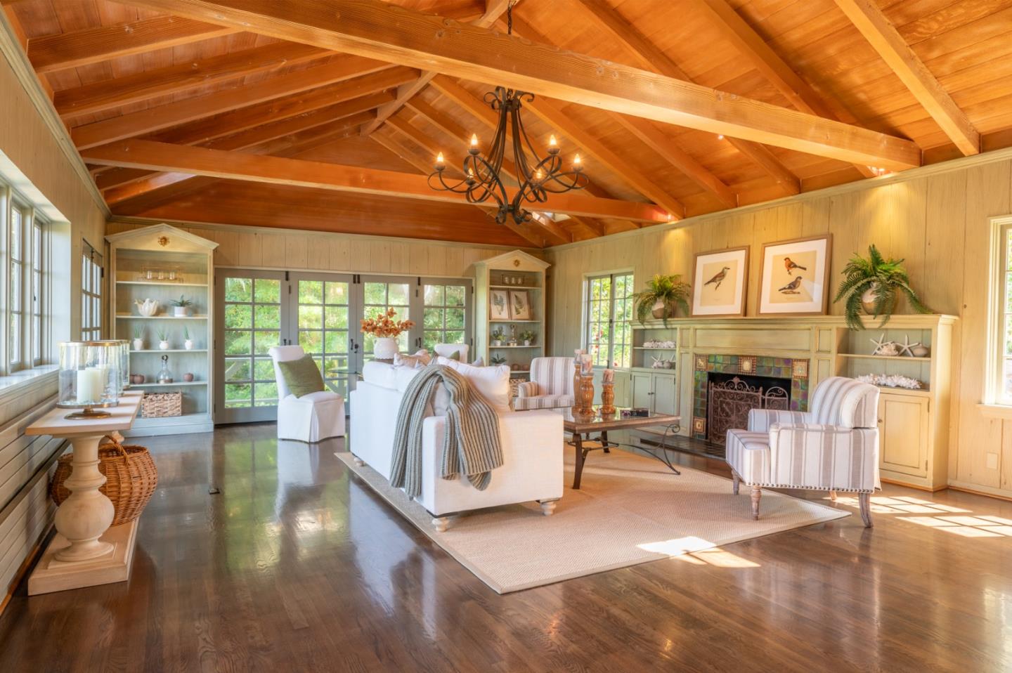 a living room with fireplace furniture and a wooden floor