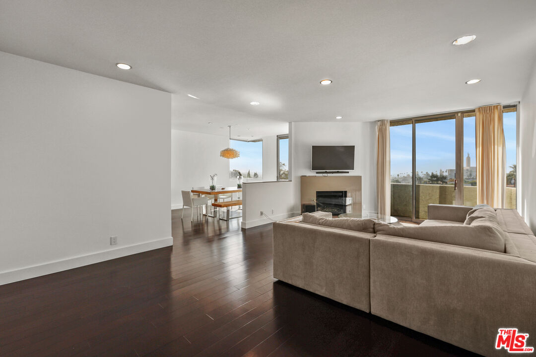 a living room with furniture wooden floor and a fireplace