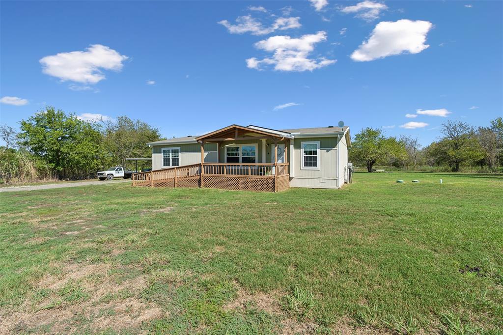 a view of a house with a backyard