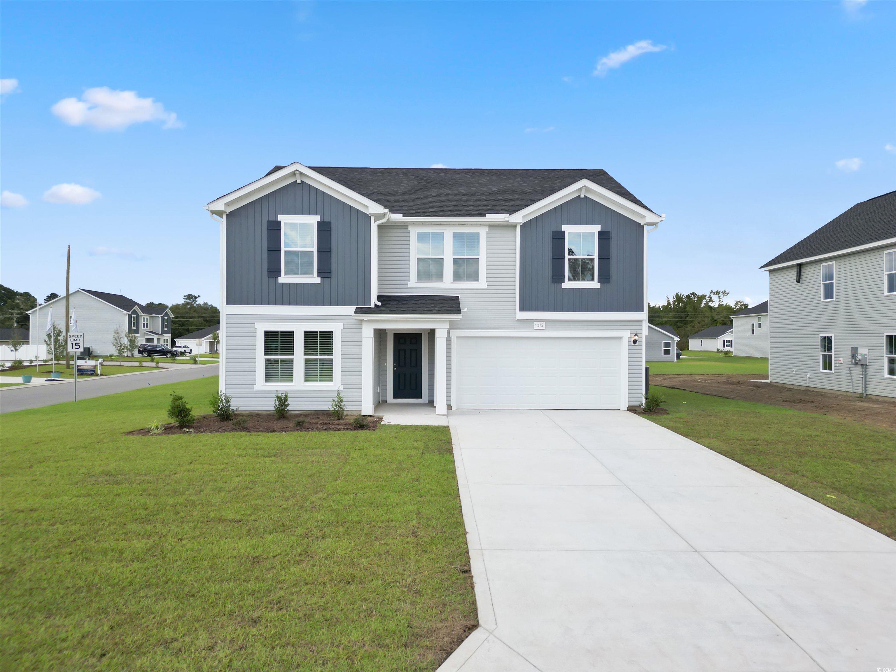 View of front facade featuring a garage and a fron