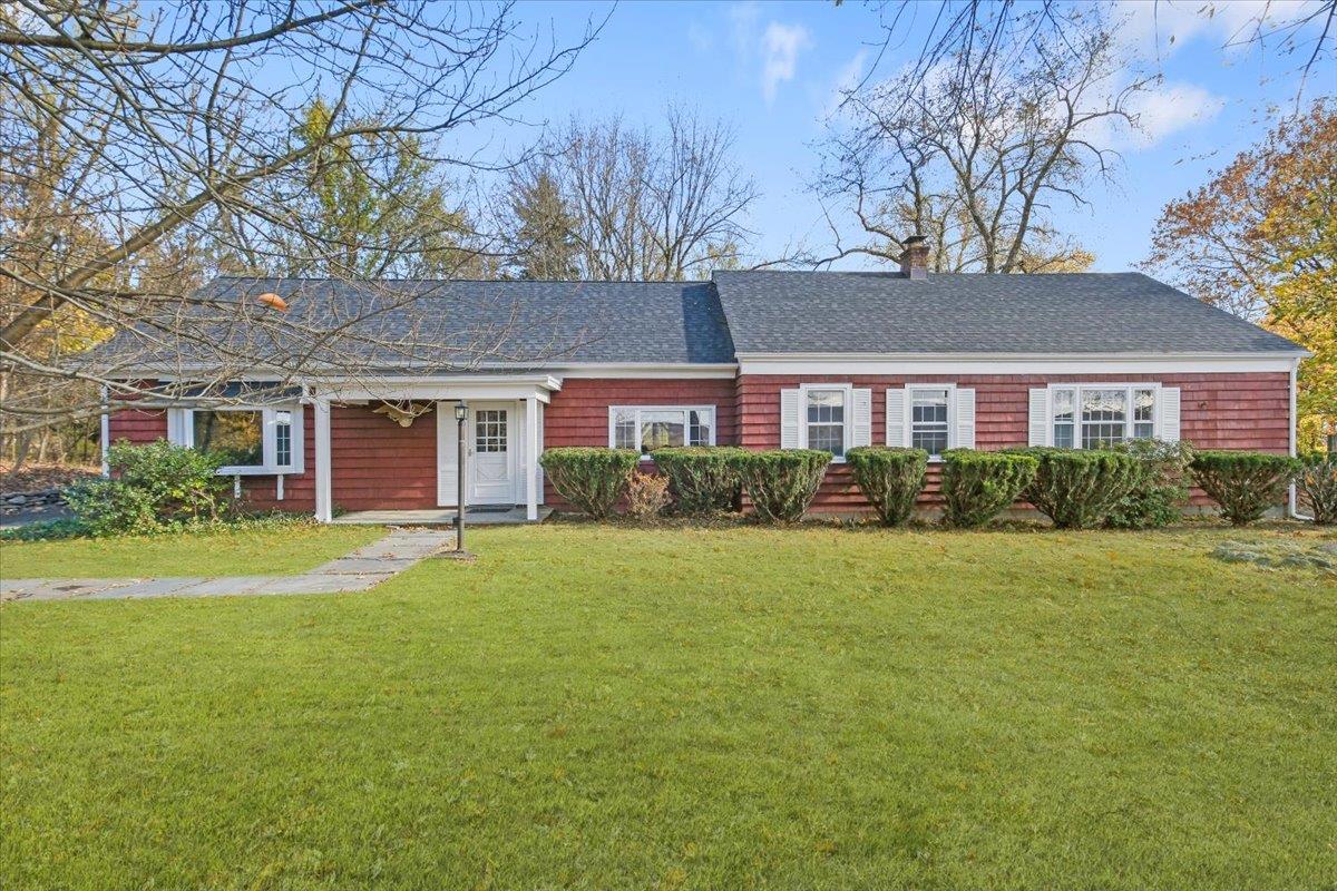 Ranch-style home featuring a front yard