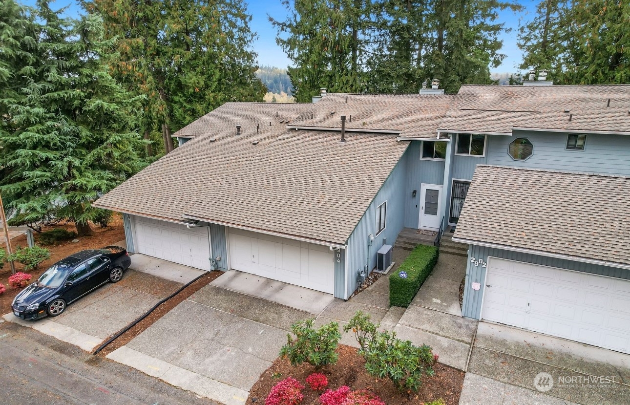 an aerial view of a house roof deck and garden