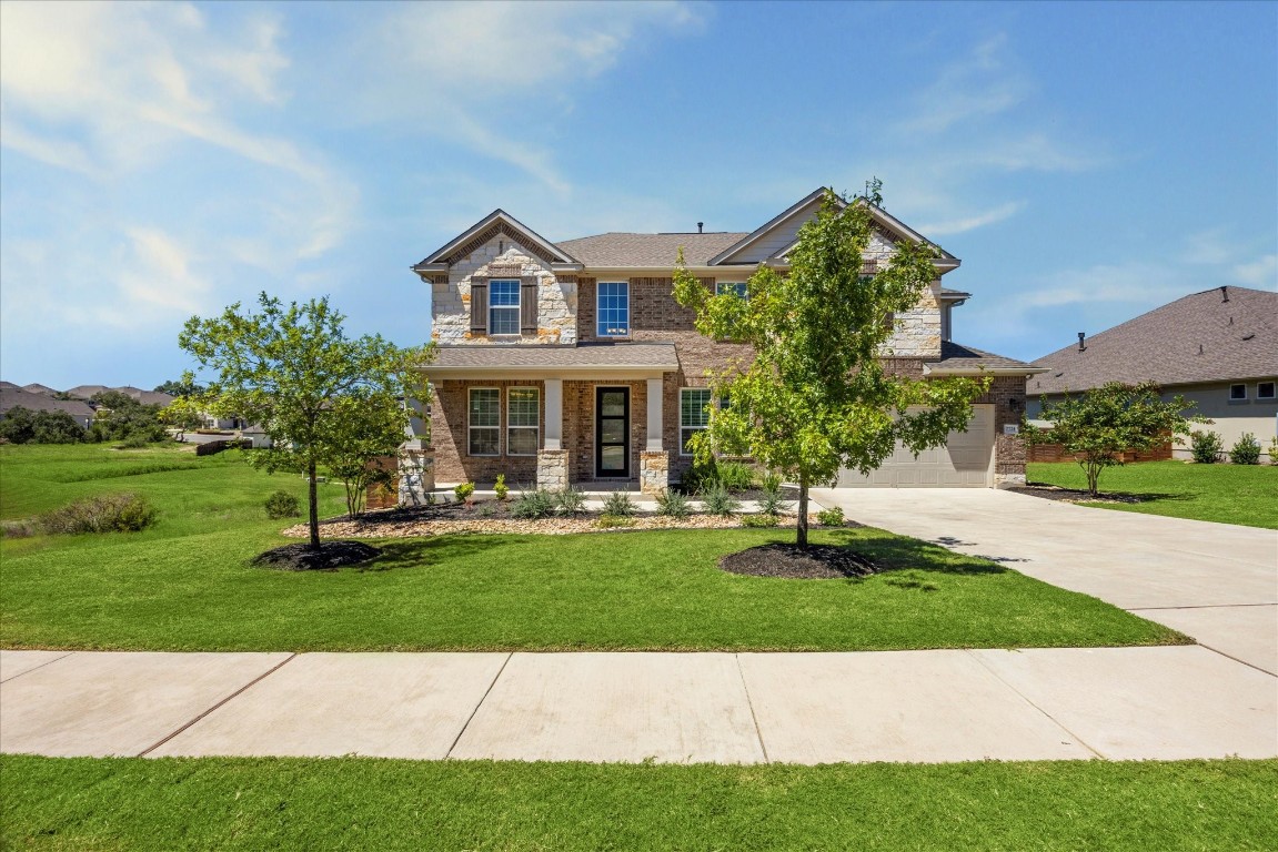 a front view of a house with a garden