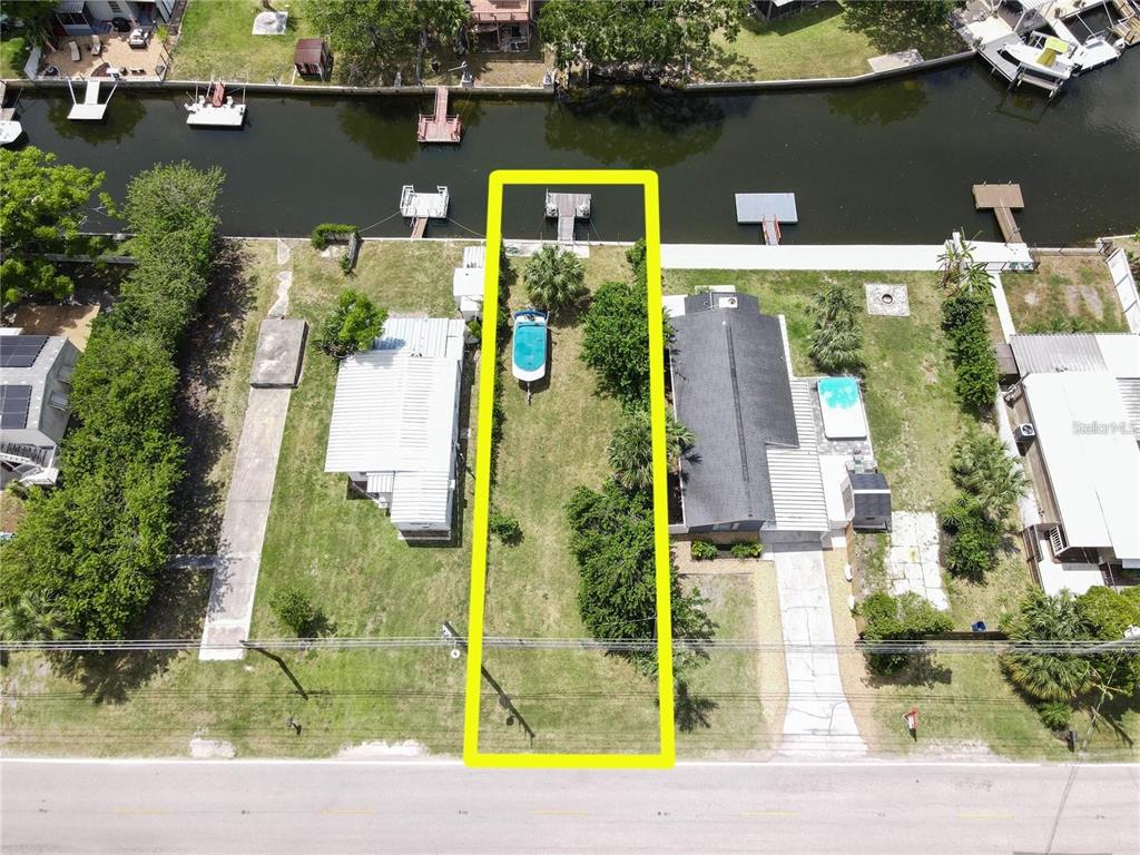 an aerial view of houses with a yard