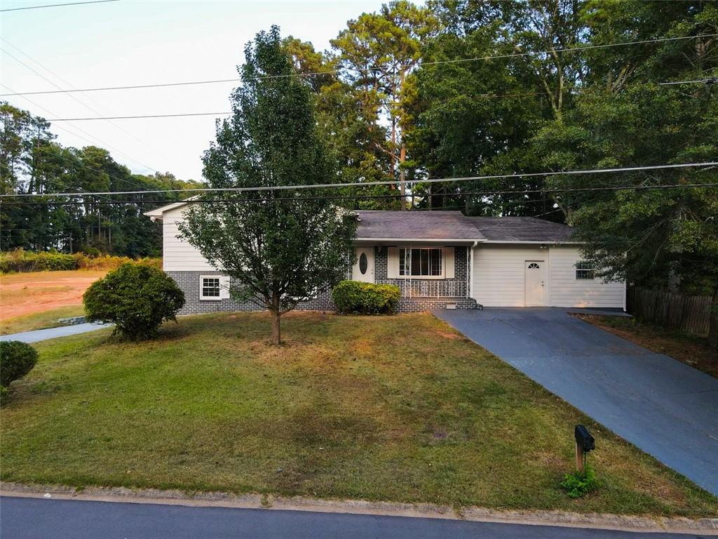 a view of house with yard