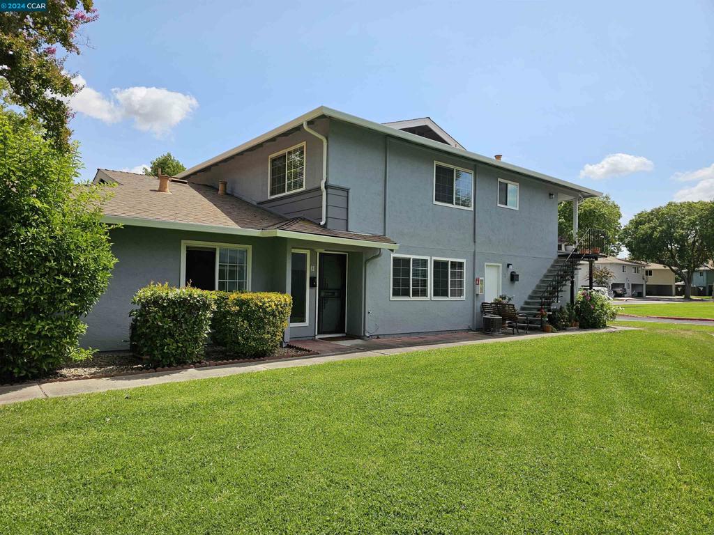 a front view of a house with a yard and porch