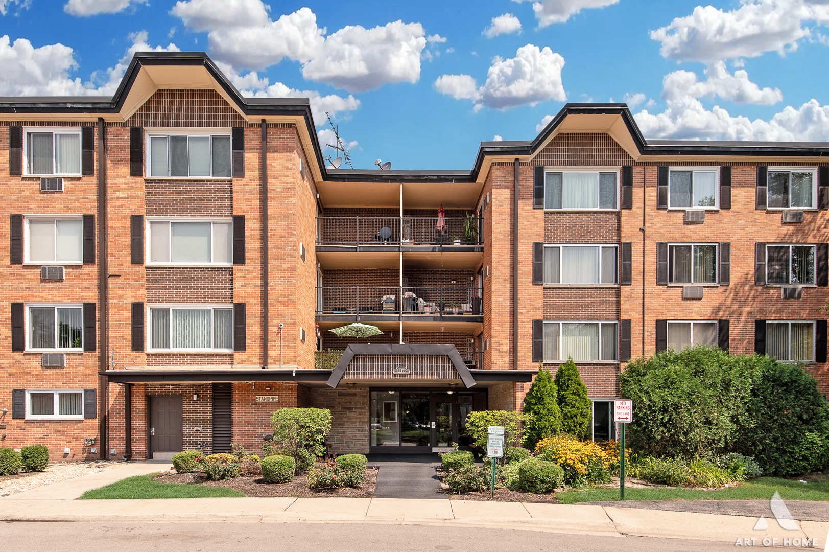 a front view of a residential apartment building with a yard