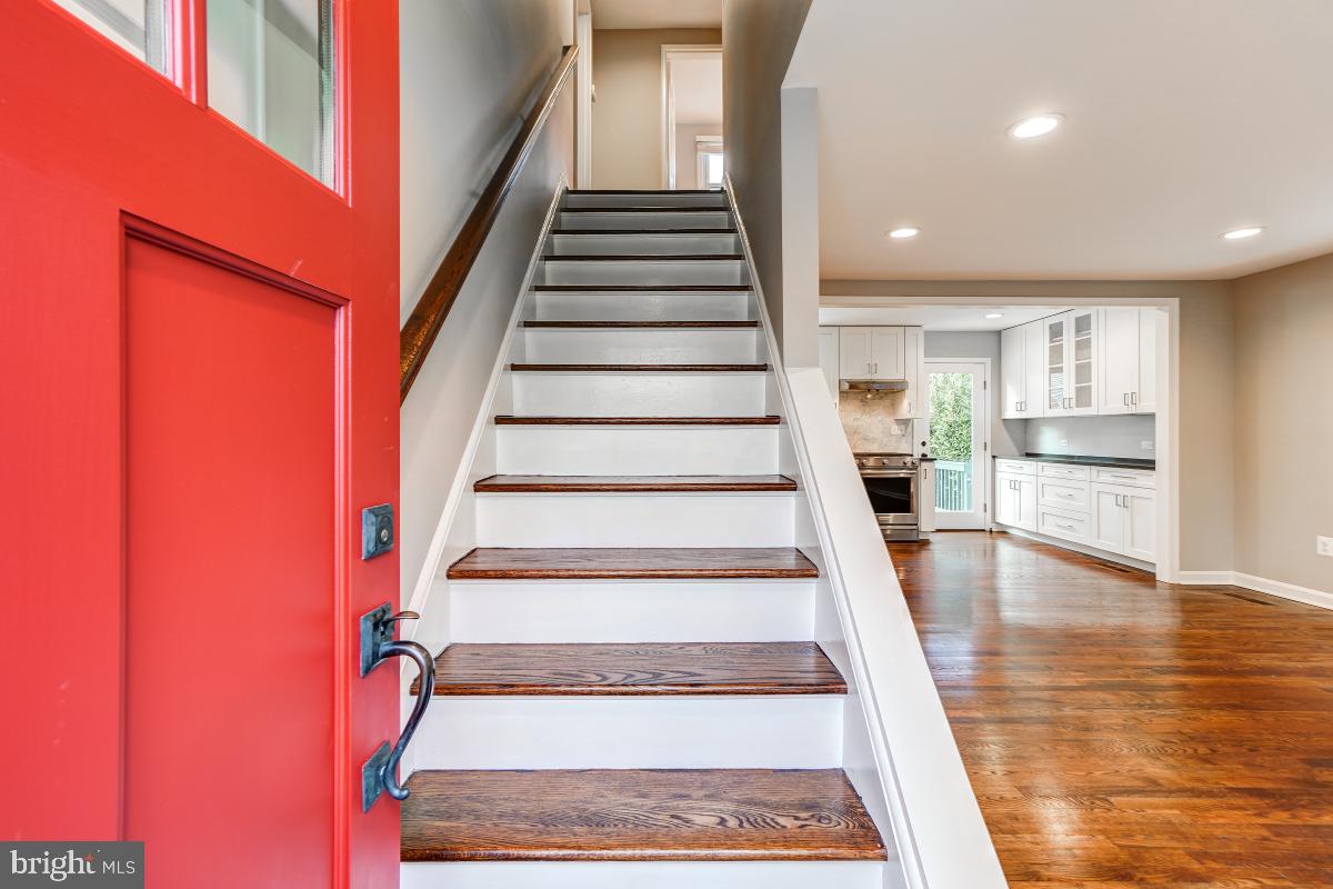 a view of entryway and hall with wooden floor