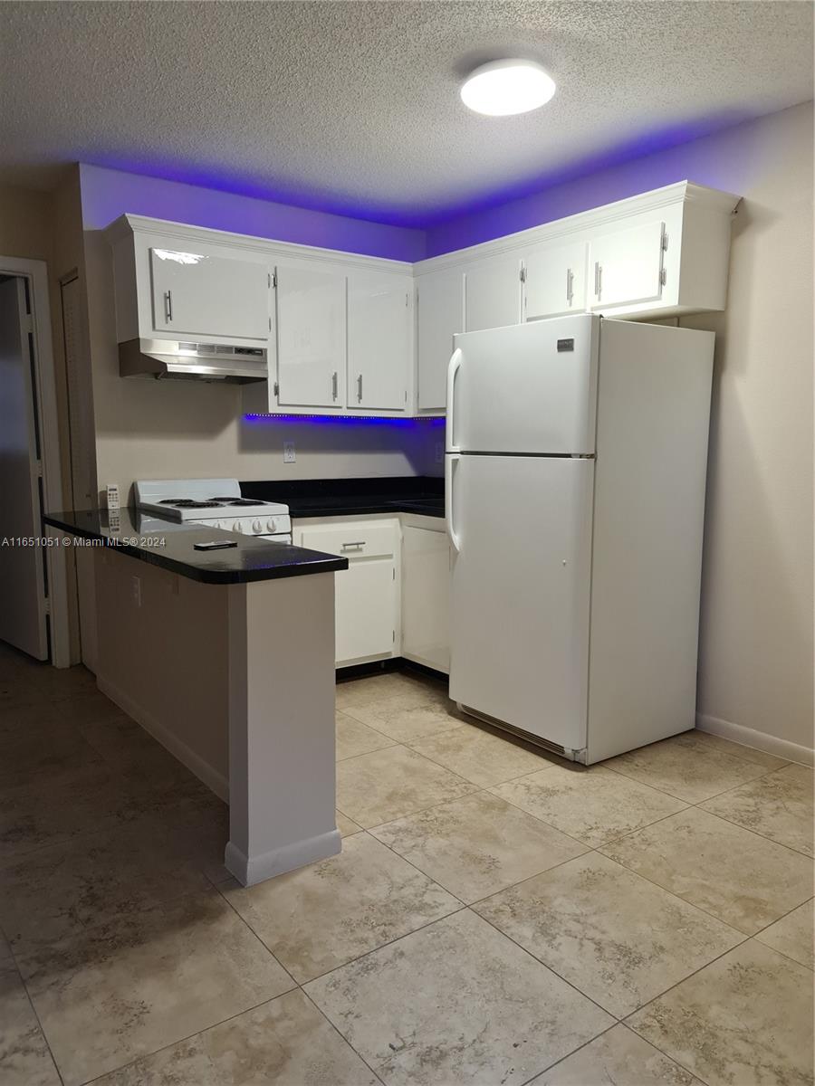 a kitchen with a sink a stove and a refrigerator