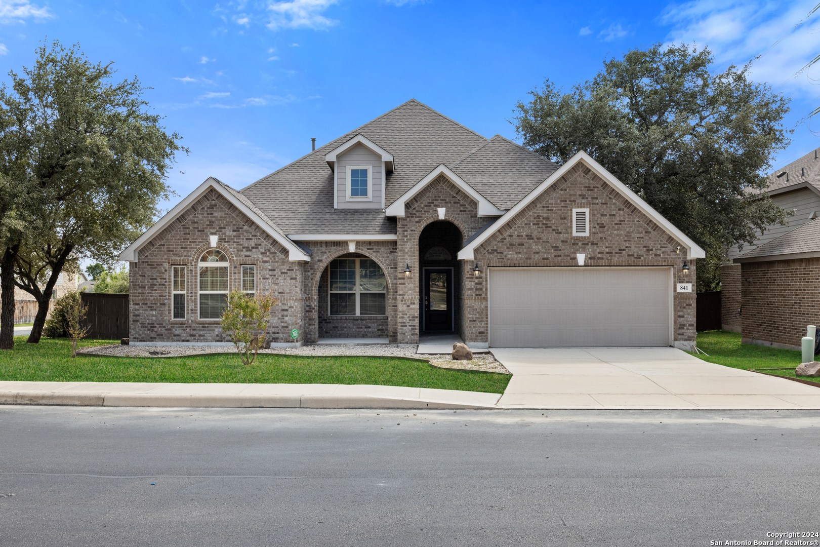 a front view of a house with a yard and garage