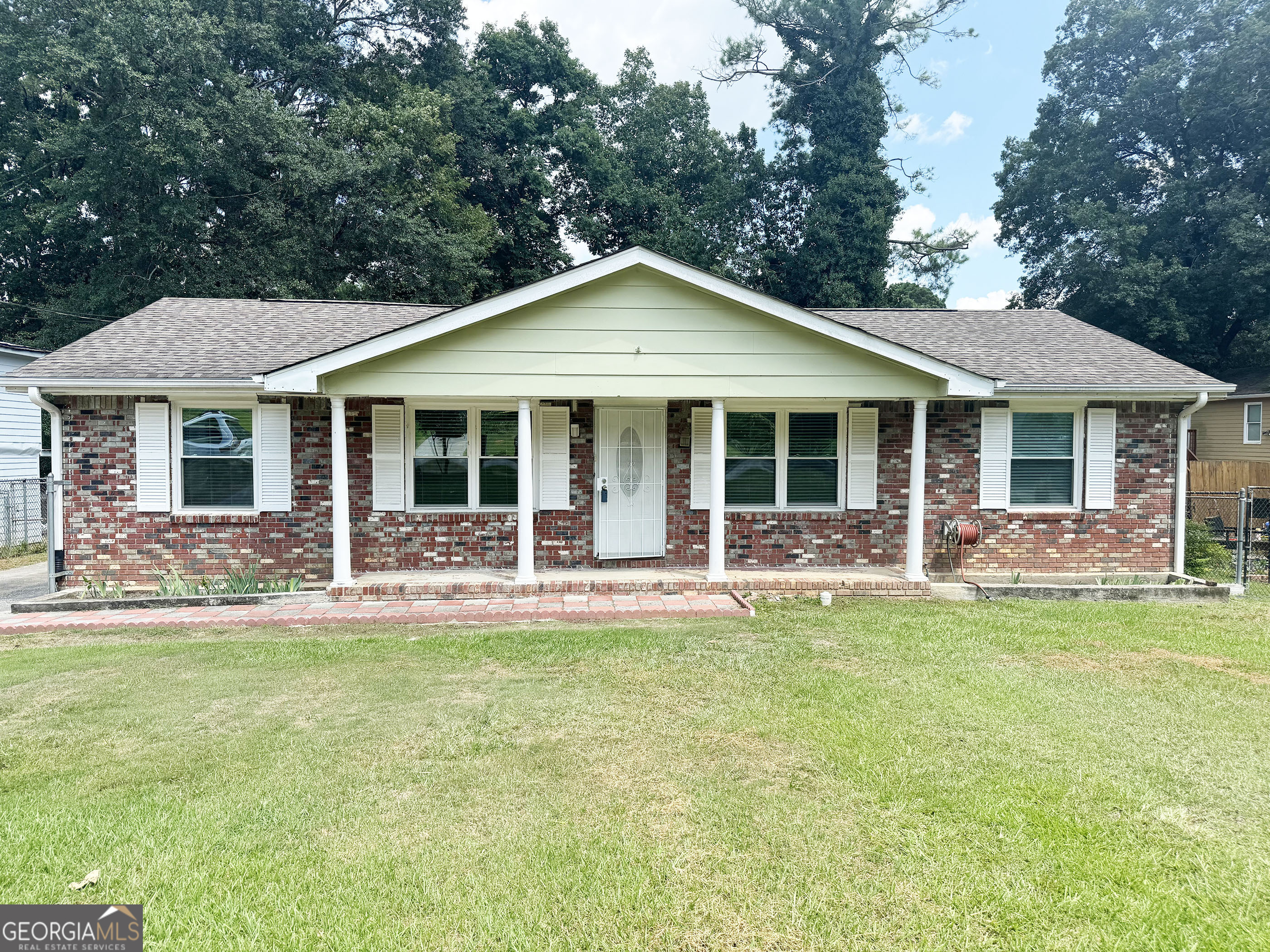 a front view of a house with a garden and porch