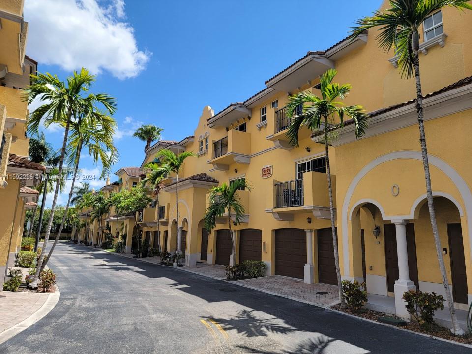 a couple of palm trees in front of a building