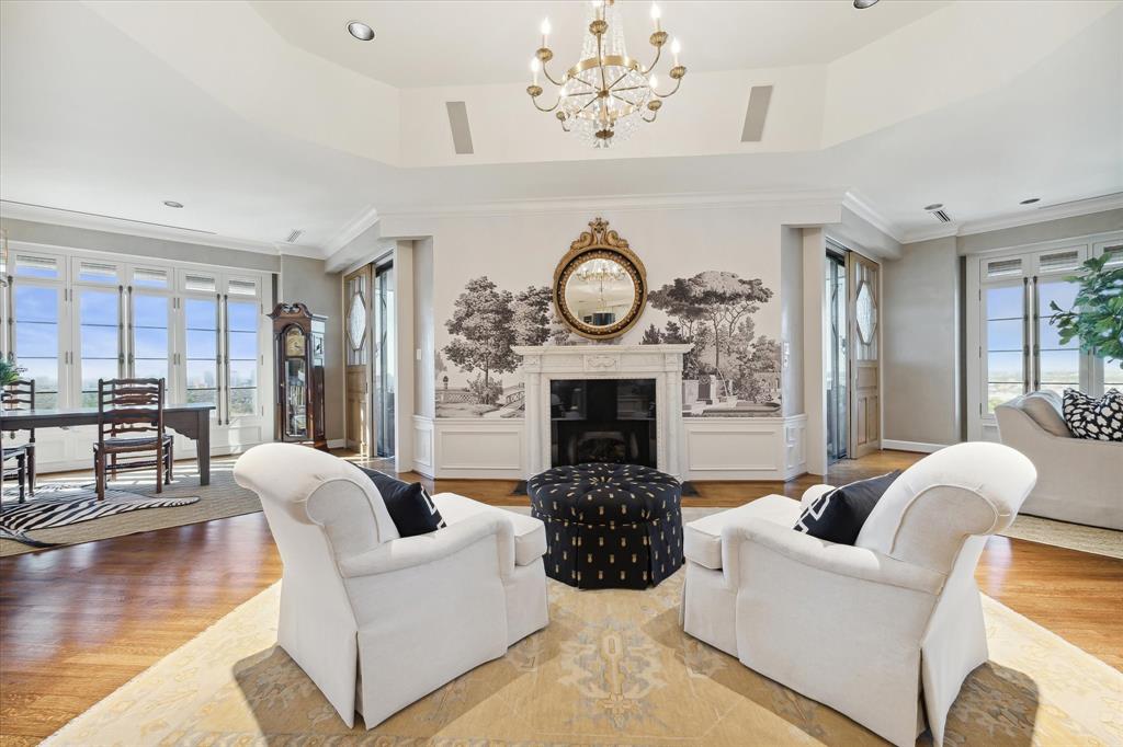 a living room with furniture a clock and a fireplace