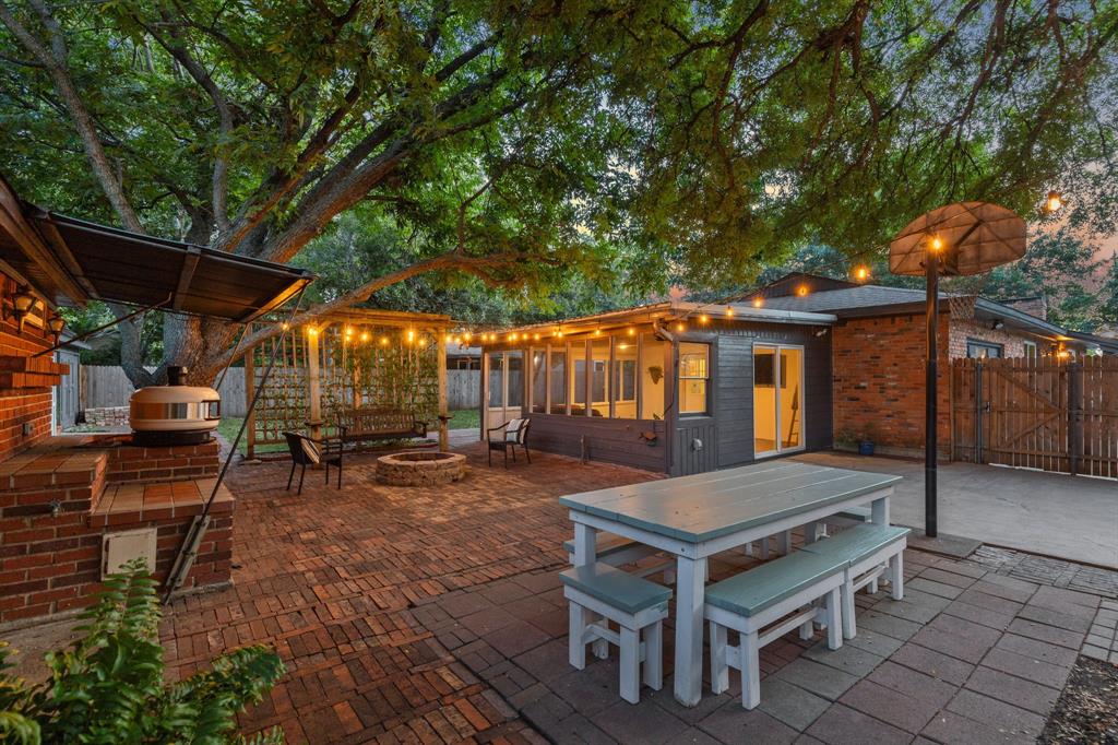 a view of patio with a table and chairs under an umbrella