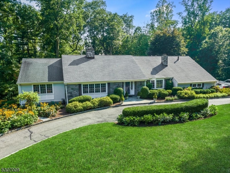 a view of house with garden and a swimming pool