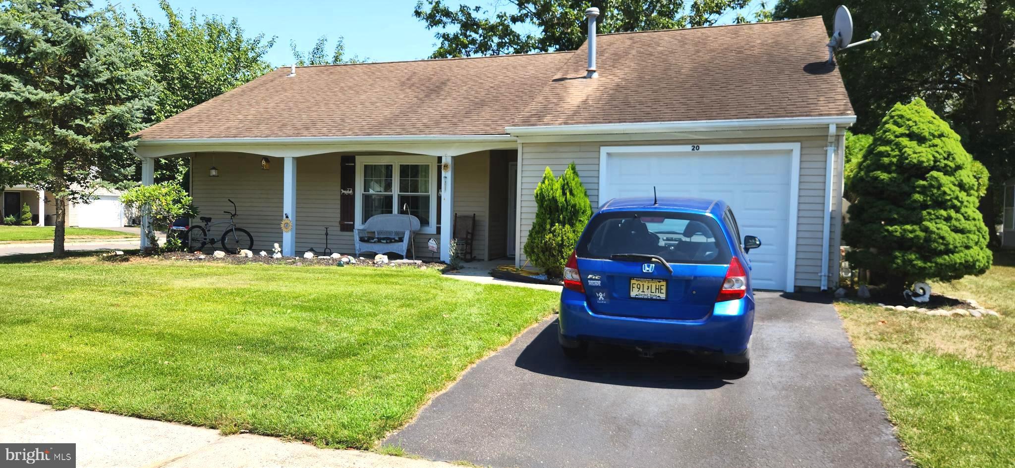 a front view of a house with a garden and porch