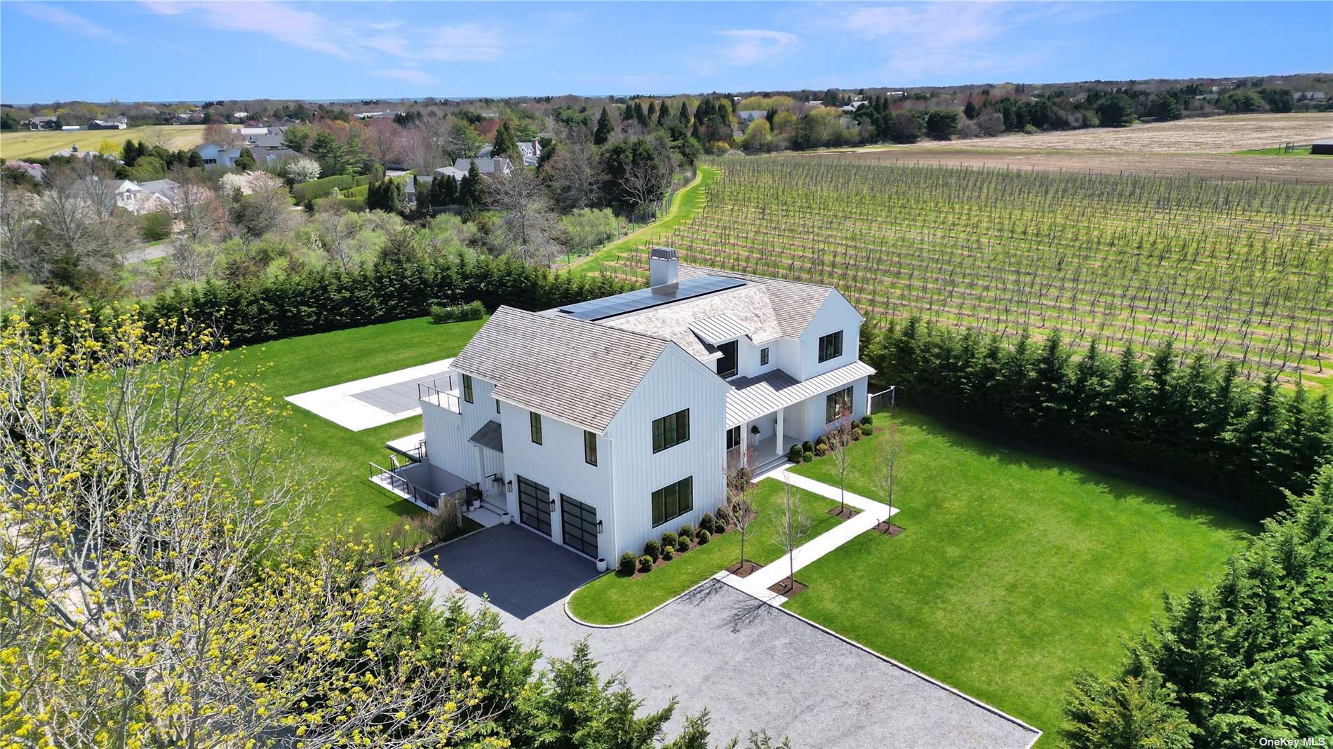 an aerial view of a house with a garden and lake view