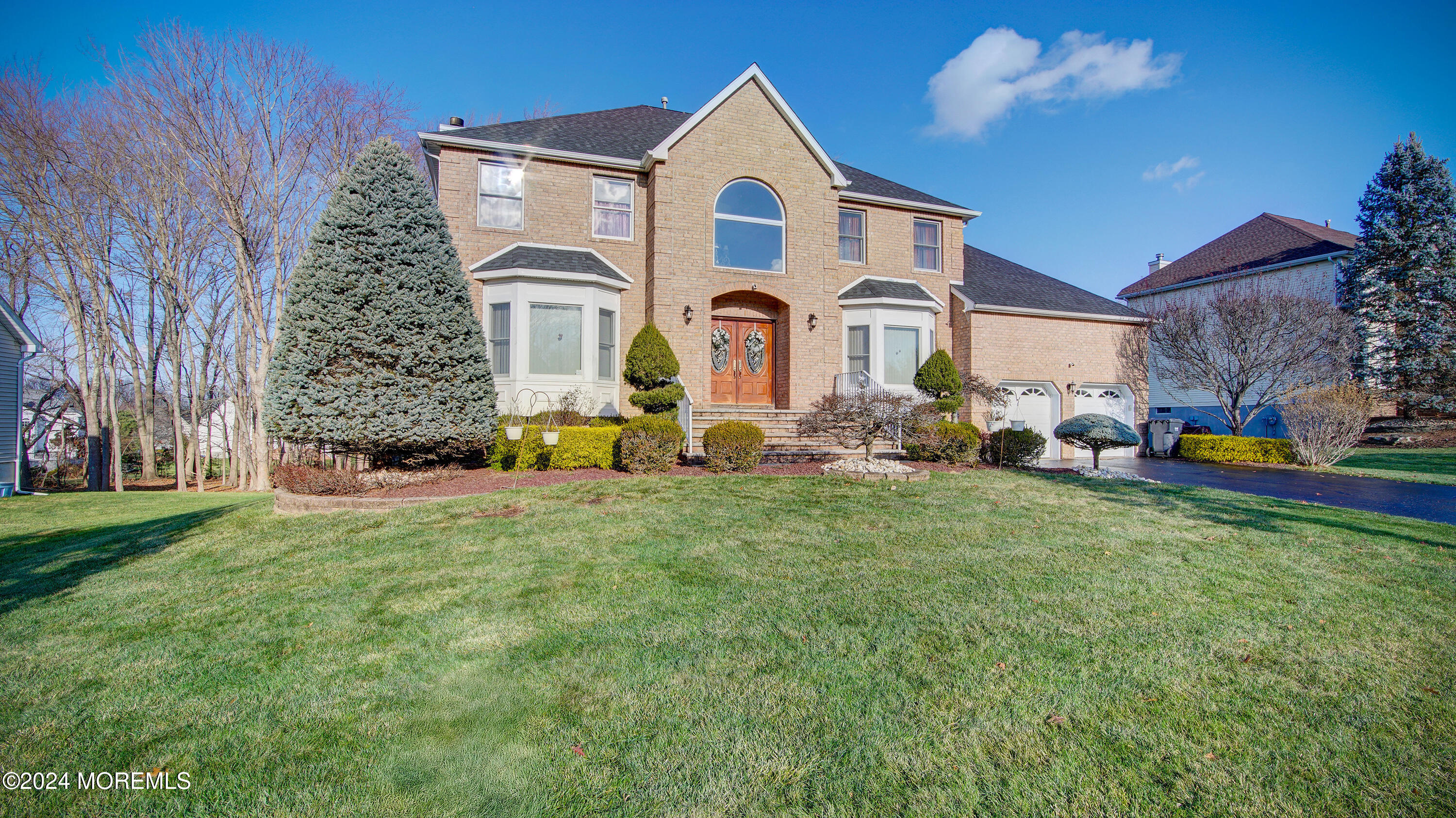 a front view of a house with a big yard