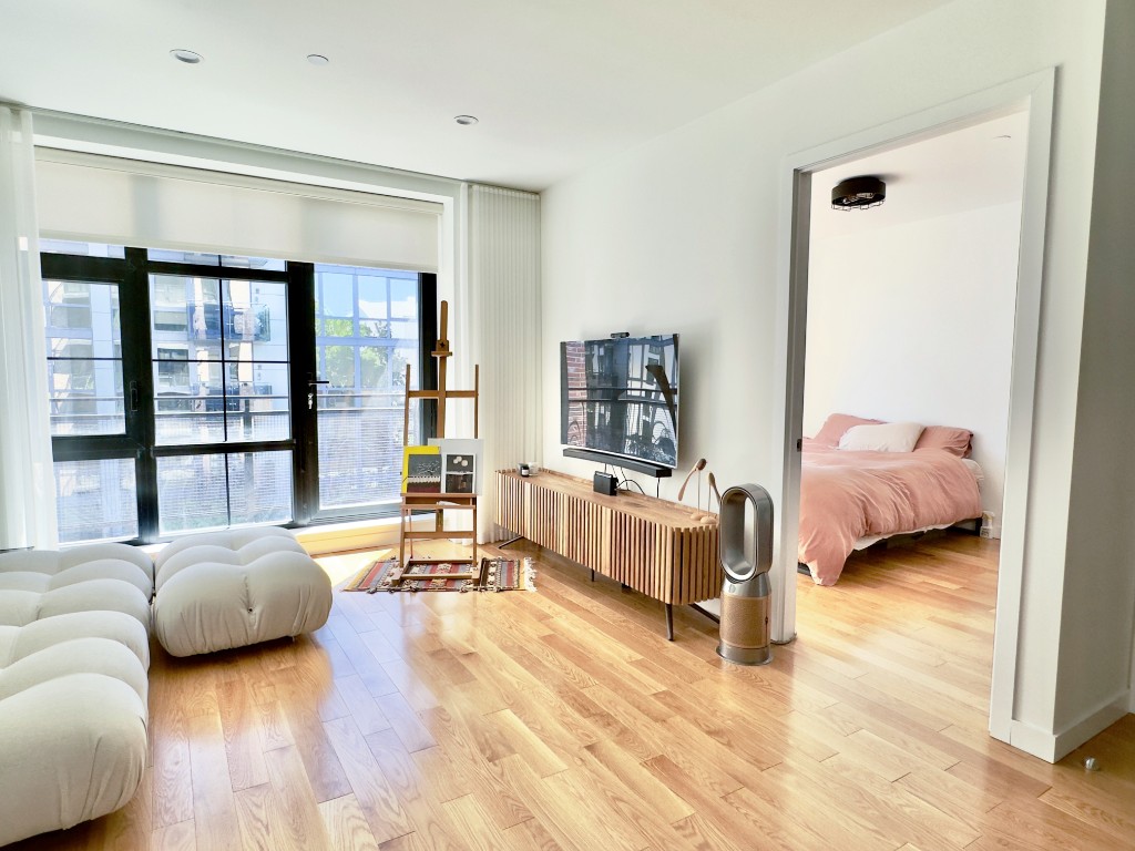 a bedroom with furniture and a large window