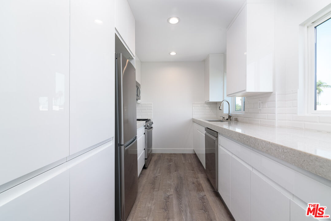 a kitchen with a refrigerator and a sink