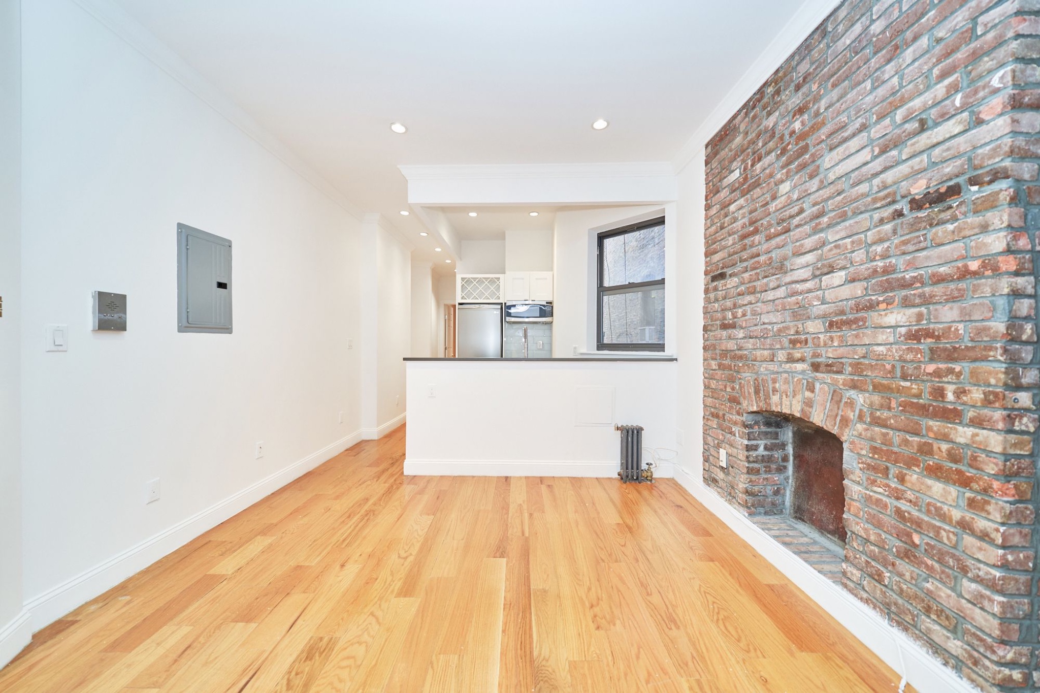 a room with a wooden floor and a fireplace