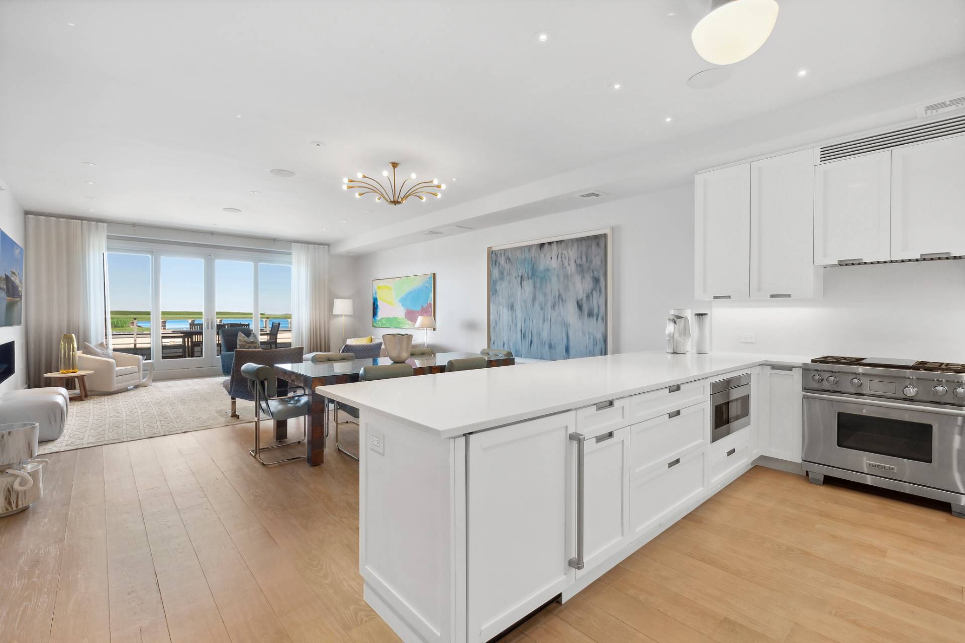 a kitchen with sink stove and cabinets with wooden floor