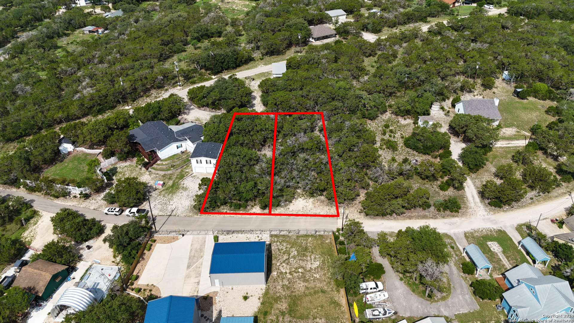 an aerial view of residential houses with outdoor space