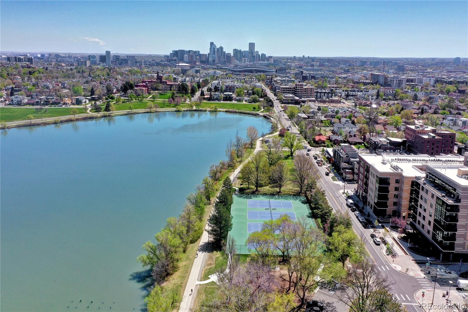 an aerial view of lake and residential houses with outdoor space