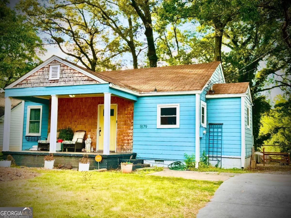 a view of a house with swimming pool and porch with furniture