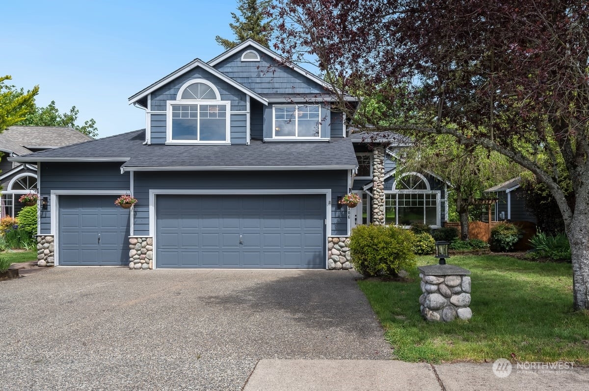 a front view of a house with a yard and garage