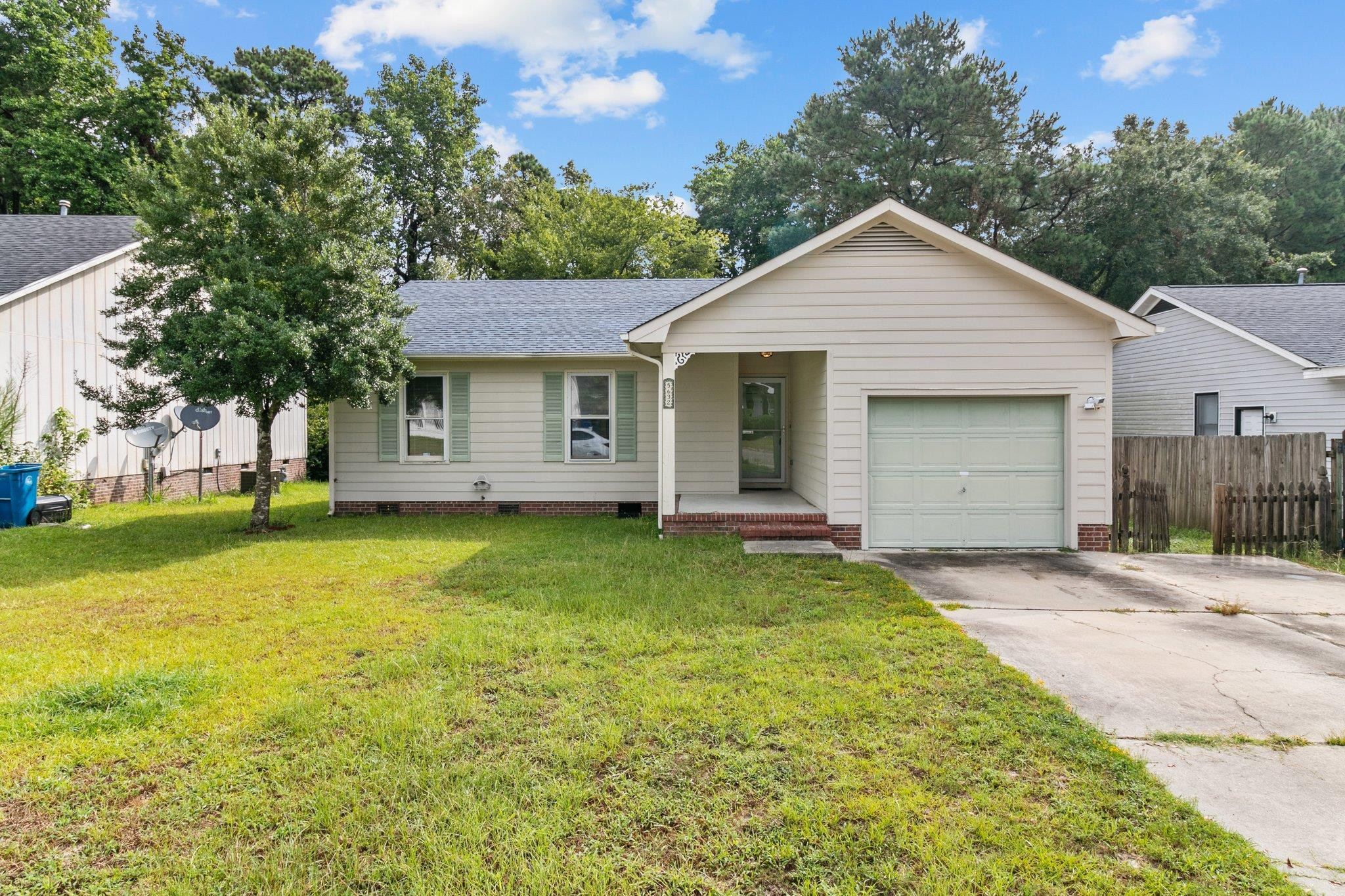 a view of a house with a yard and garage