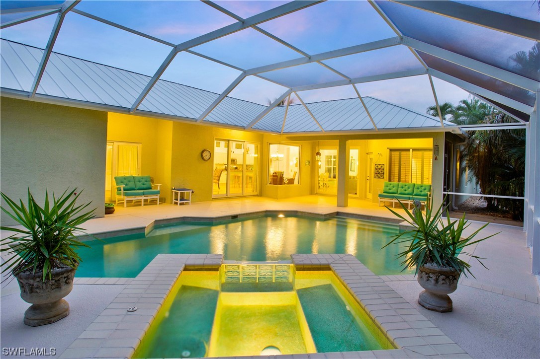 a swimming pool with lawn chairs under an umbrella