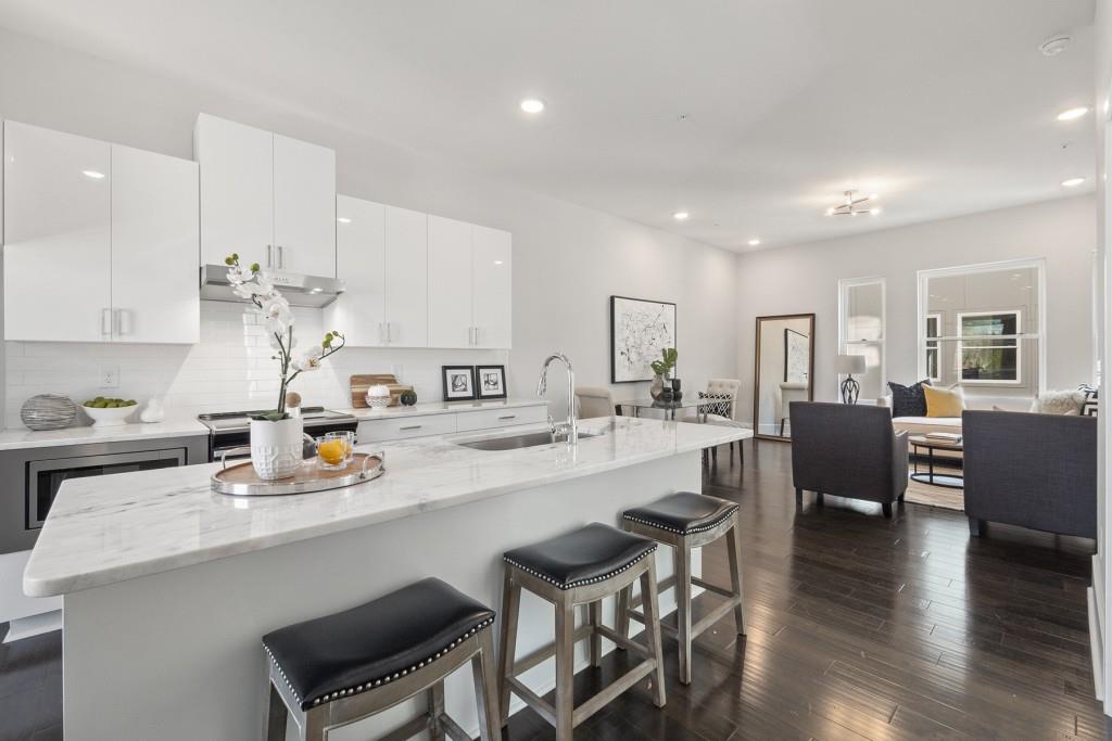 a large kitchen with a table and chairs