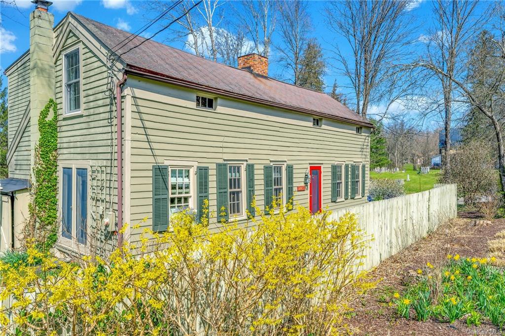 a view of a house with wooden fence