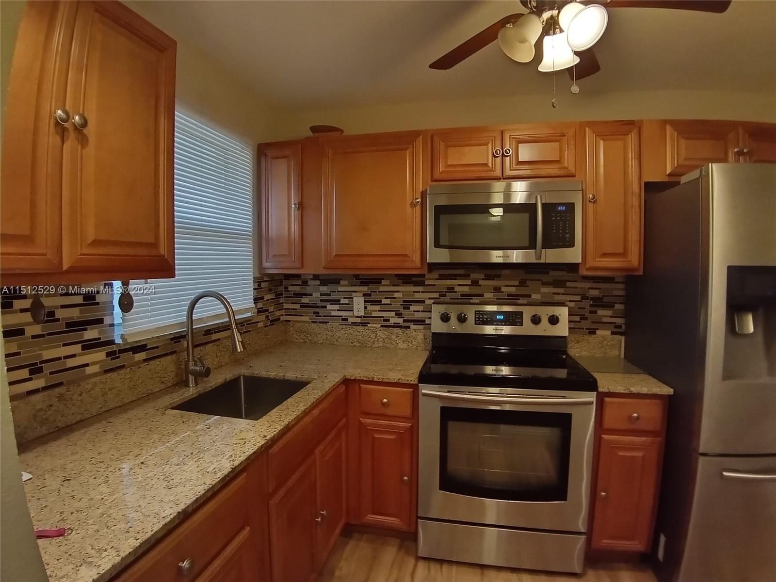 a kitchen with a stove microwave and sink