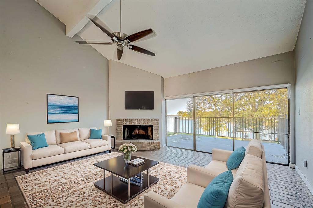 Virtual Staging of the second floor living room, showing the beautiful view of the Lake Conroe.