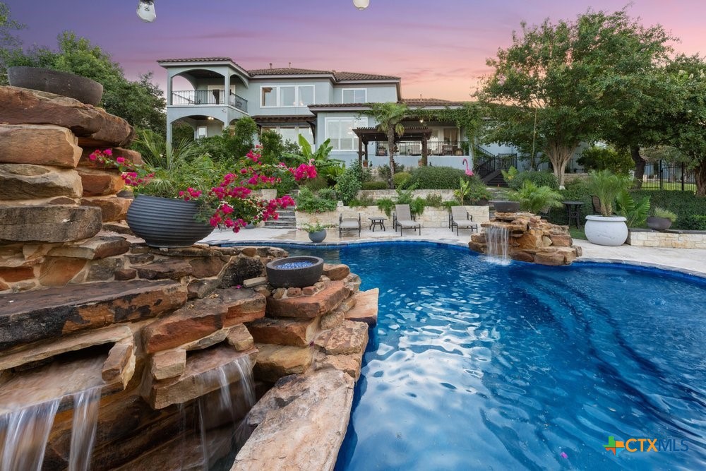 a view of a chairs and table in the backyard