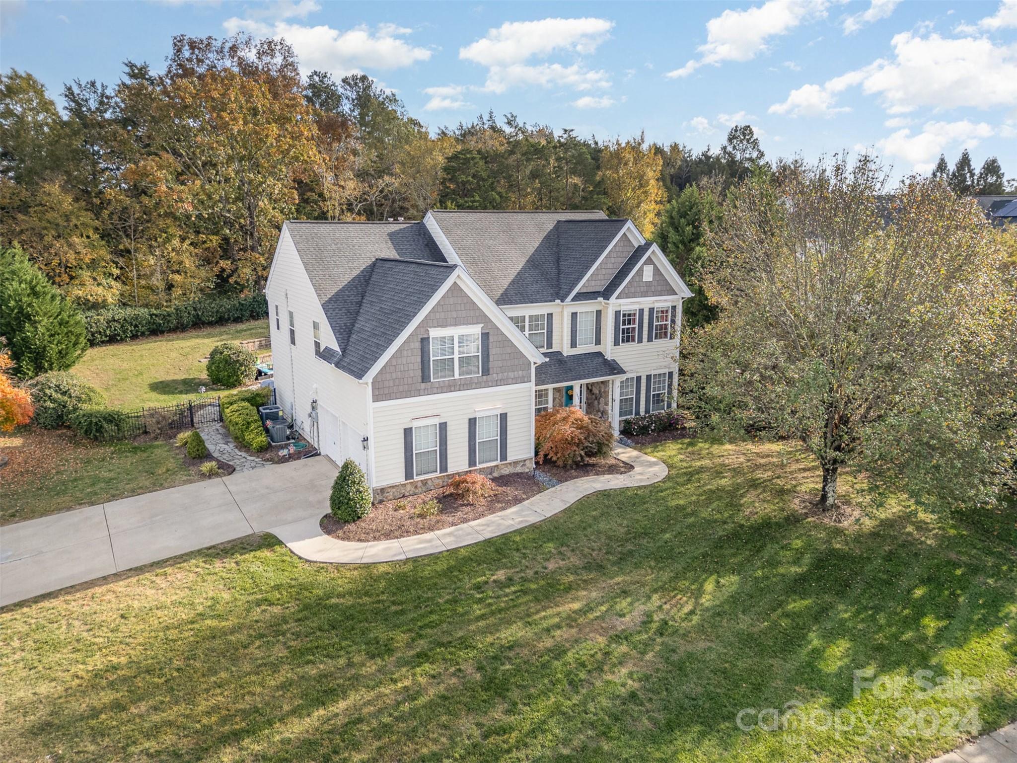 a aerial view of a house next to a yard