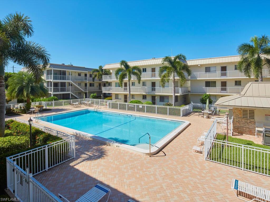 a view of swimming pool with outdoor seating and deck