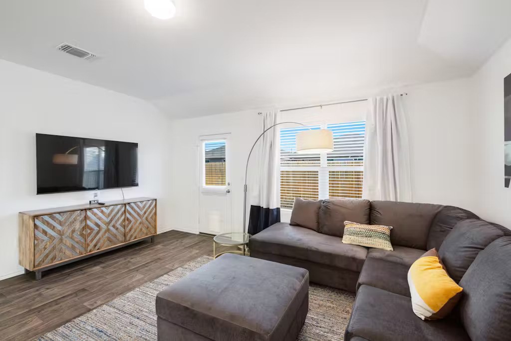 a living room with furniture and a flat screen tv