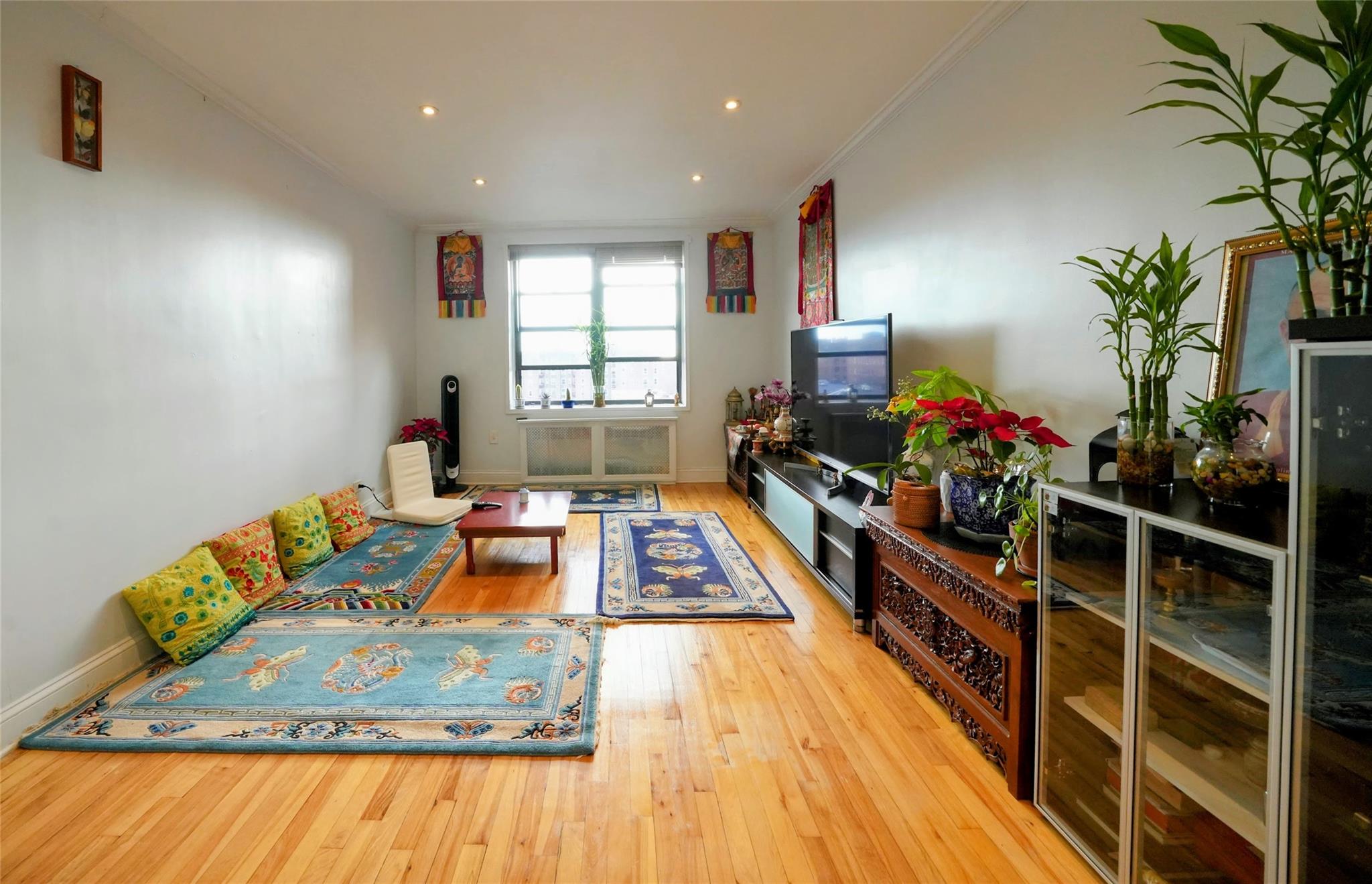 Living room featuring light hardwood / wood-style floors and ornamental molding