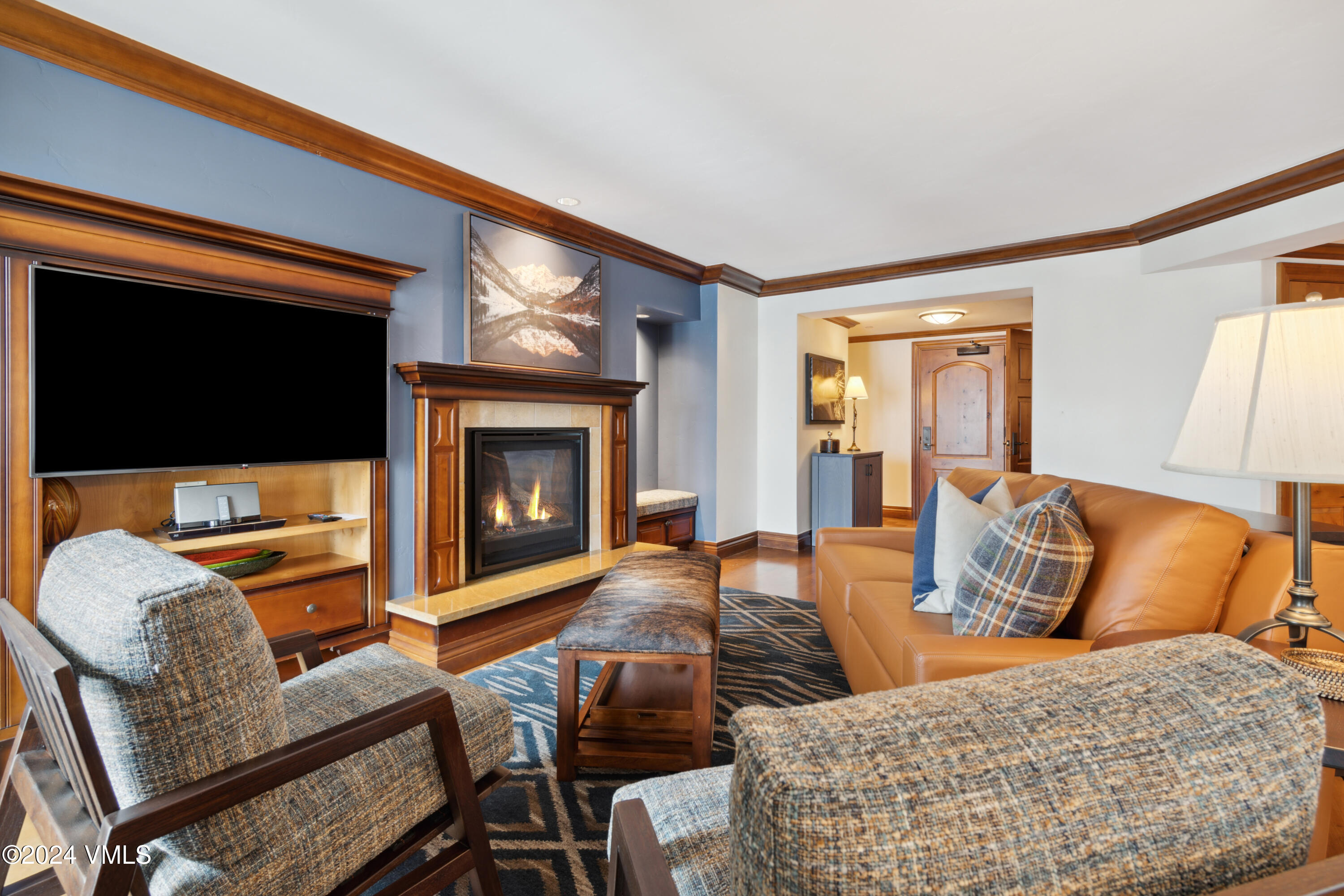 a living room with furniture a flat screen tv and a fireplace