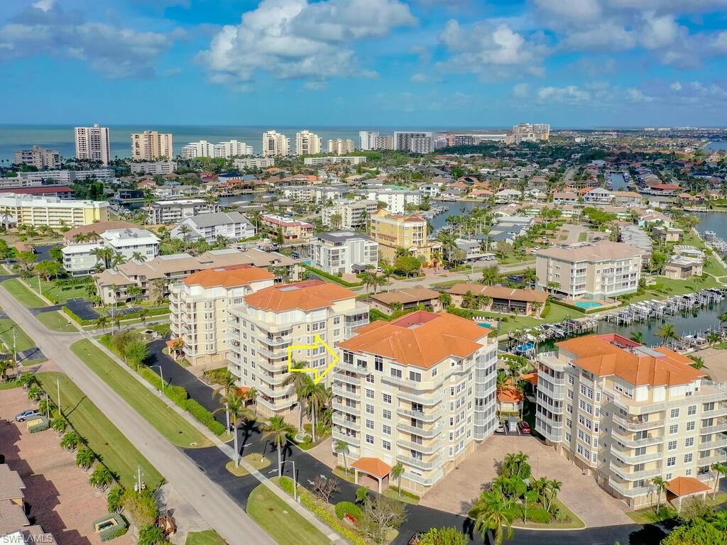 Birds eye view of property with a water view