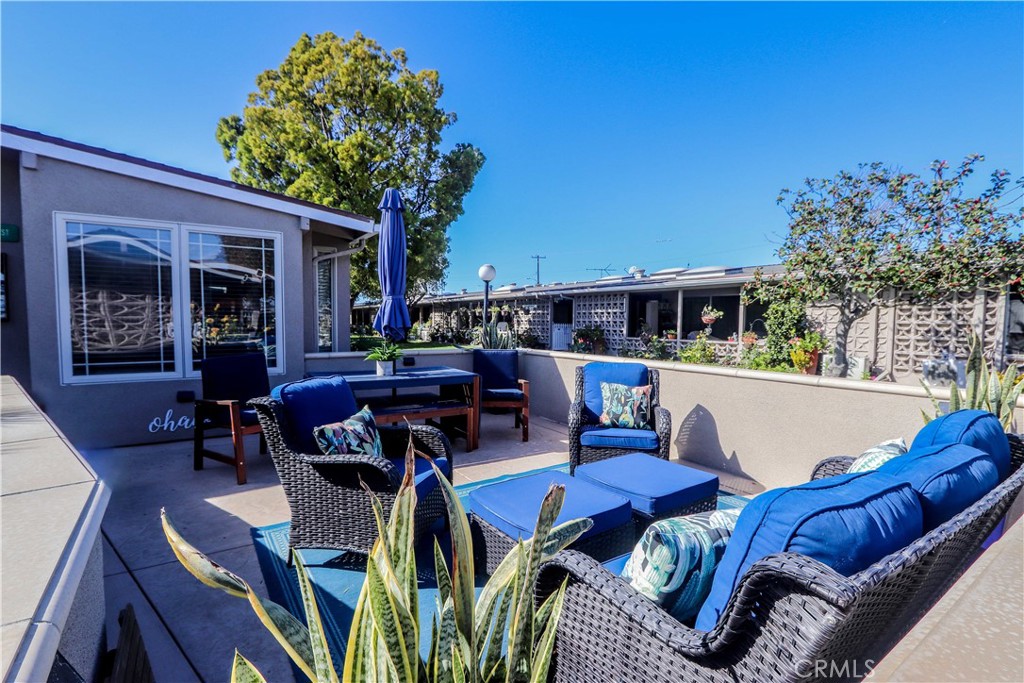 a view of a chairs and table in patio with a fire pit