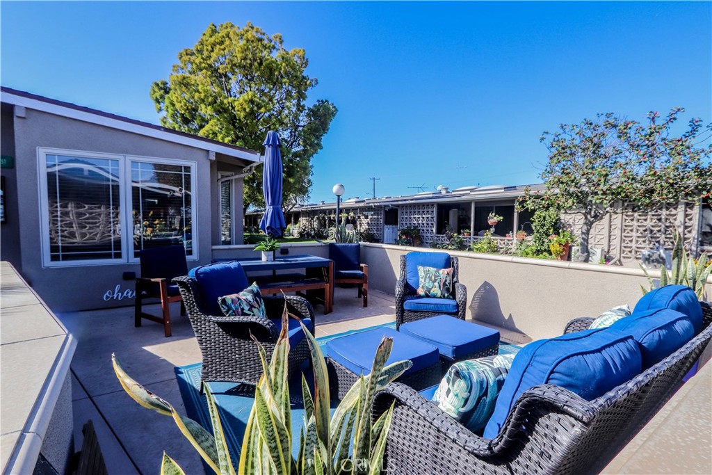 a view of a chairs and table in patio with a fire pit