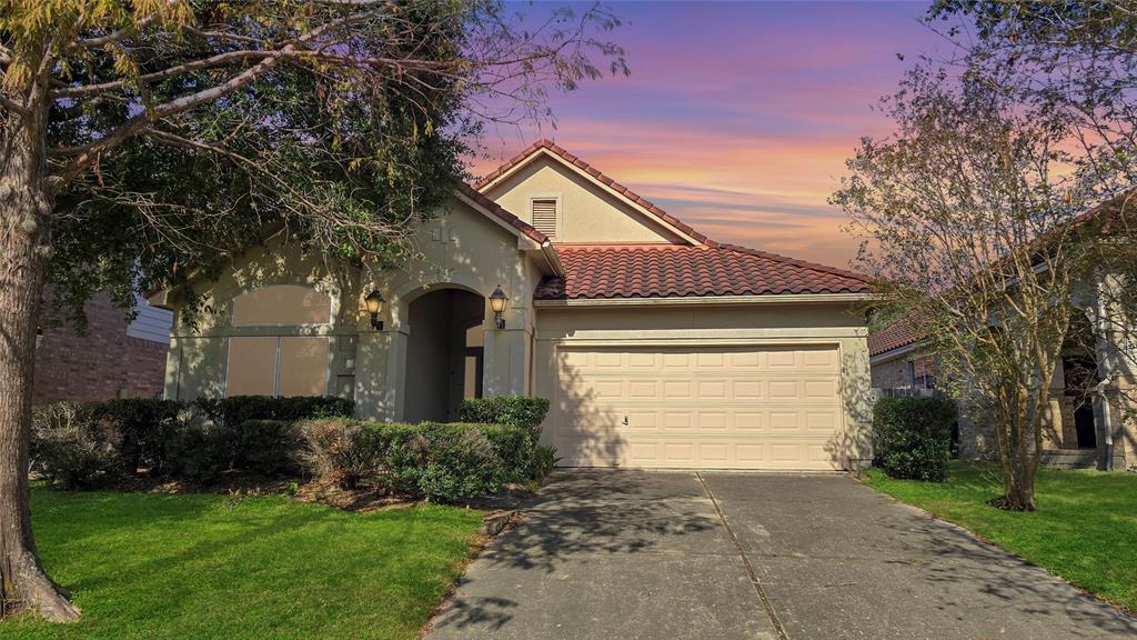 a front view of a house with a yard and garage