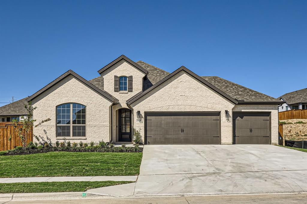 a view of a house with a yard and garage